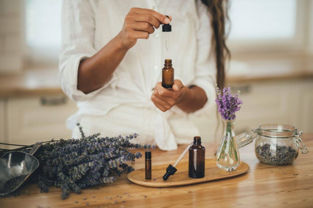 A woman holds essential oil and fresh lavender highlighting natural wellness