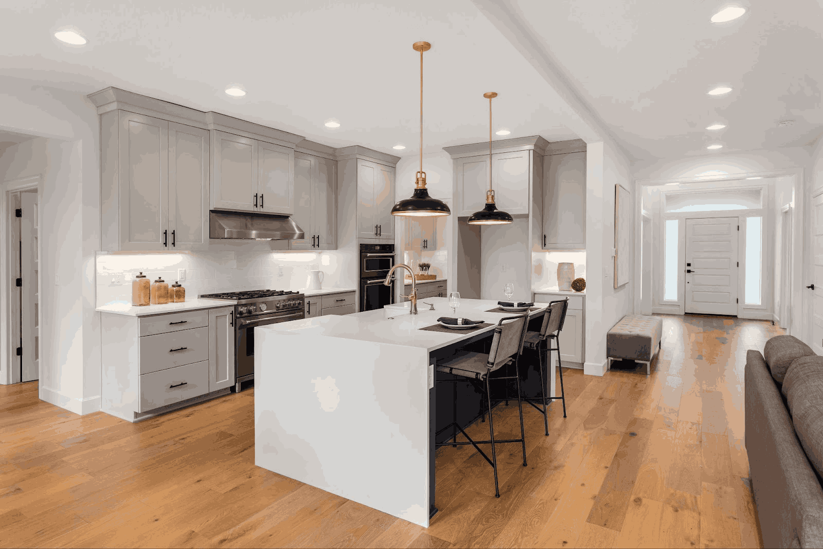 Stylish kitchen interior with white cabinets and a central island, highlighting the work of Intermountain Stone and Marble.