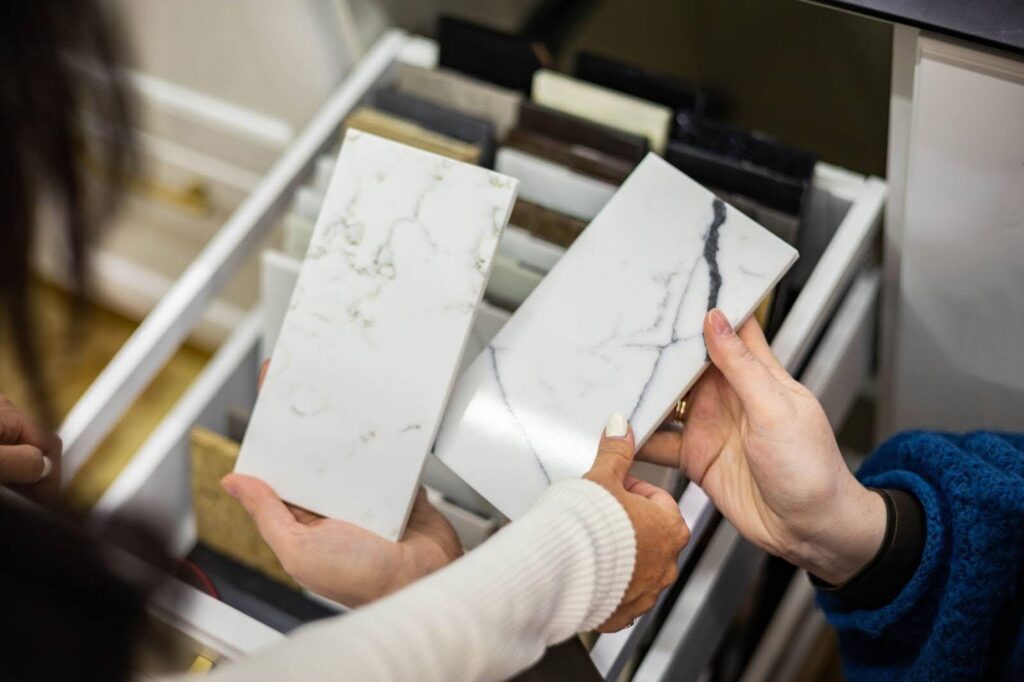 A woman holds a piece of marble in her hand, showcasing its smooth texture and natural beauty